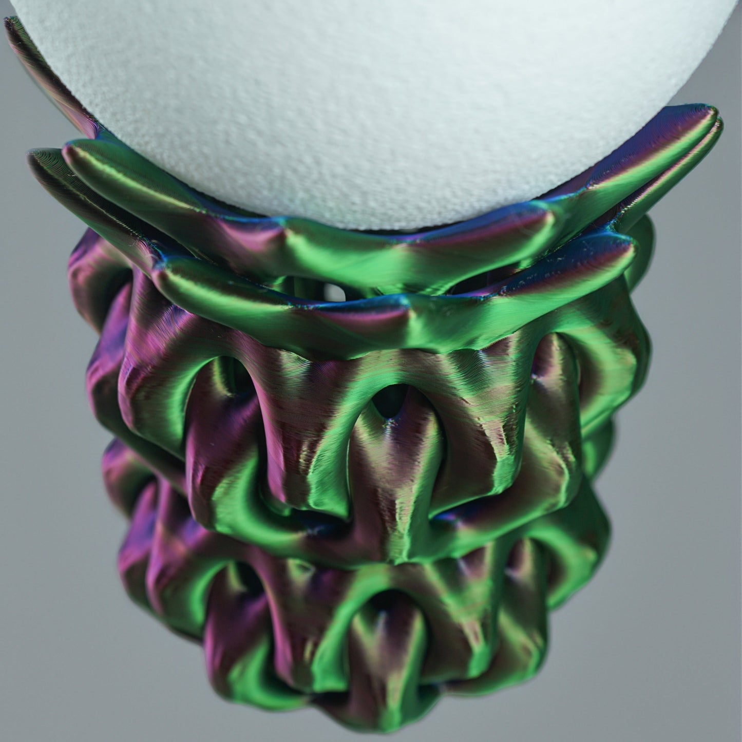 Top Down view of a Decorative lamp with a colorful, textured base on a gray background